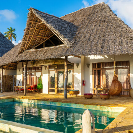 Morning view of a luxury villa on the tropical beach near sea on the island of Zanzibar, Tanzania, East Africa