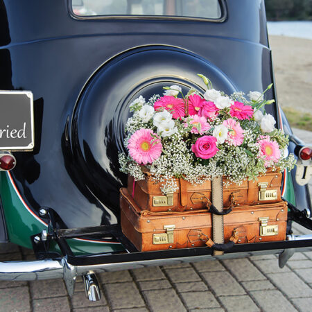 Wedding bouquet on vintage wedding car
